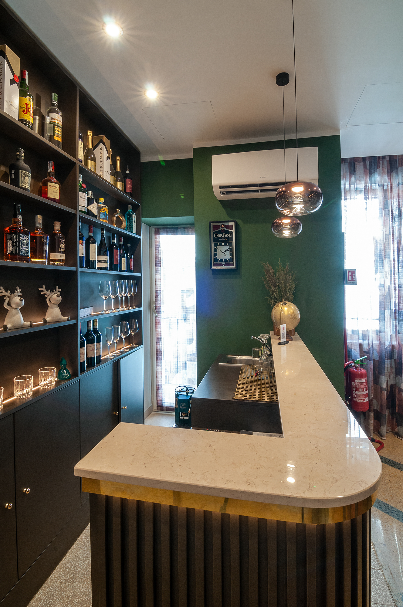 The bar counter with spirits and crystal glassware